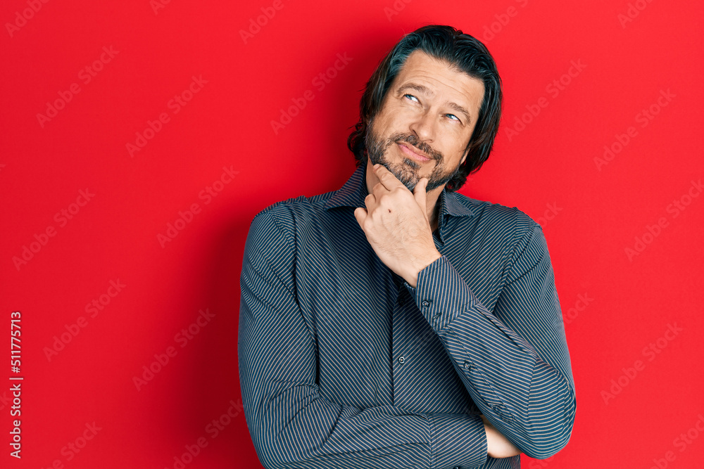 Middle age caucasian man wearing casual clothes with hand on chin thinking about question, pensive expression. smiling with thoughtful face. doubt concept. Middle age caucasian man wearing casual clothes with hand on chin thinking about question, pensive expression. smiling with thoughtful face. doubt concept.