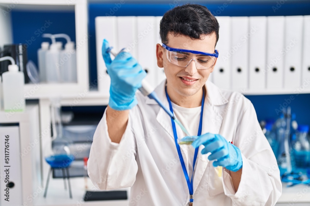 Young non binary man scientist smiling confident using pipette at laboratory Young non binary man scientist smiling confident using pipette at laboratory
