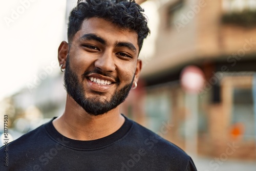 Fotografia Young arab man smiling confident at street