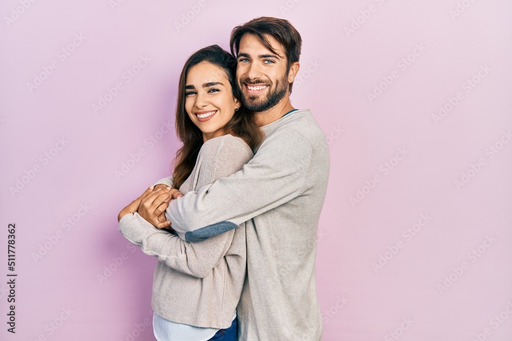 Young hispanic couple wearing casual clothes looking to side, relax profile pose with natural face and confident smile. Young hispanic couple wearing casual clothes looking to side, relax profile pose with natural face and confident smile.