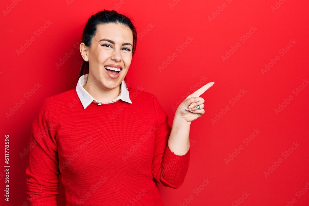 Young hispanic woman wearing casual clothes smiling happy pointing with hand and finger to the side