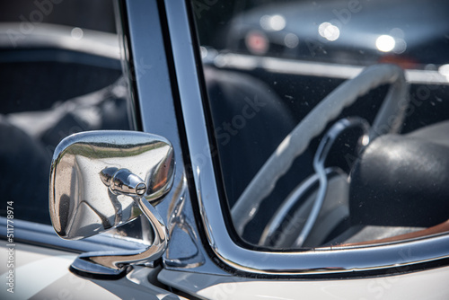 Chrome side mirror of a classic, vintage car.