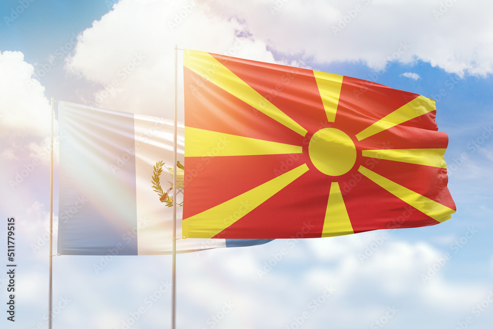 Sunny blue sky and flags of north macedonia and guatemala Sunny blue sky and flags of north macedonia and guatemala
