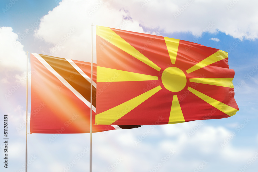 Sunny blue sky and flags of north macedonia and trinidad and tobago