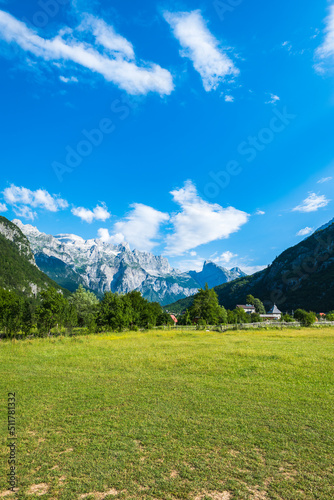 Theth mountain village / Theth National Park landscape in Albania with mountain range of Albanian Alps in the background.