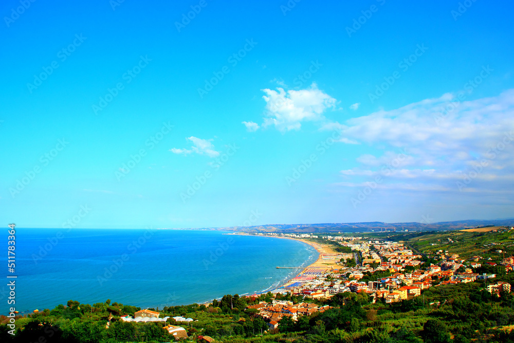 Impressive panorama from the Vasto town in Abruzzo region with peaceful green land descending to the populated coastline washed by the serene blue waters of the Adriatic Sea on a fine summer day