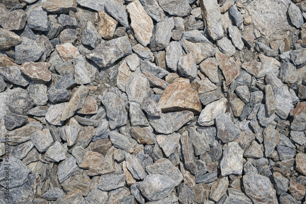 Lots of grey granite stones as abstract nature background.