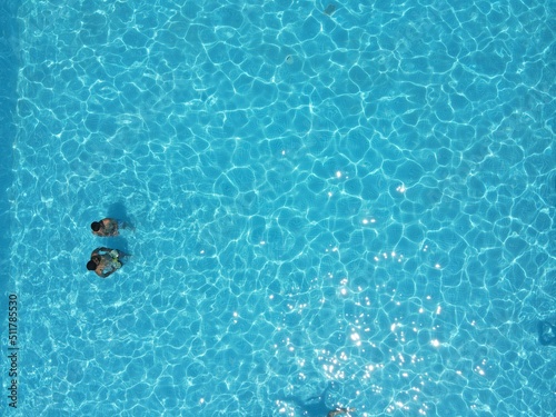 Swimming people in the pool top view
