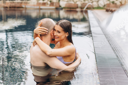 Couple in love swimming together in the pool