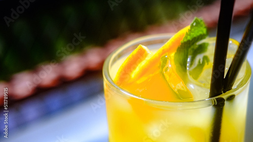 Ice cold fresh orange maraquia lemonade dressed with mint and orange slices in a glass photo