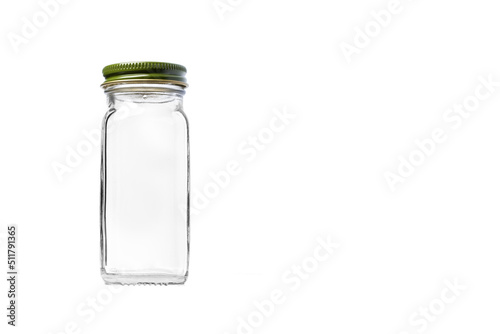 Photo Empty Square Glass jar for seasoning with Green Cap isolated on white background