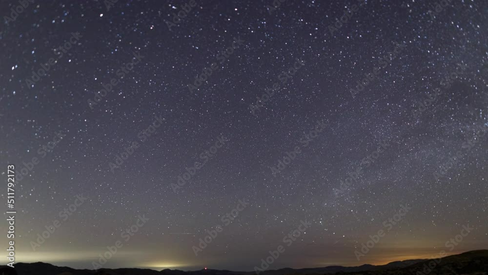 Time lapse of star trails over desert landscape in California, USA Time lapse of star trails over desert landscape in California, USA
