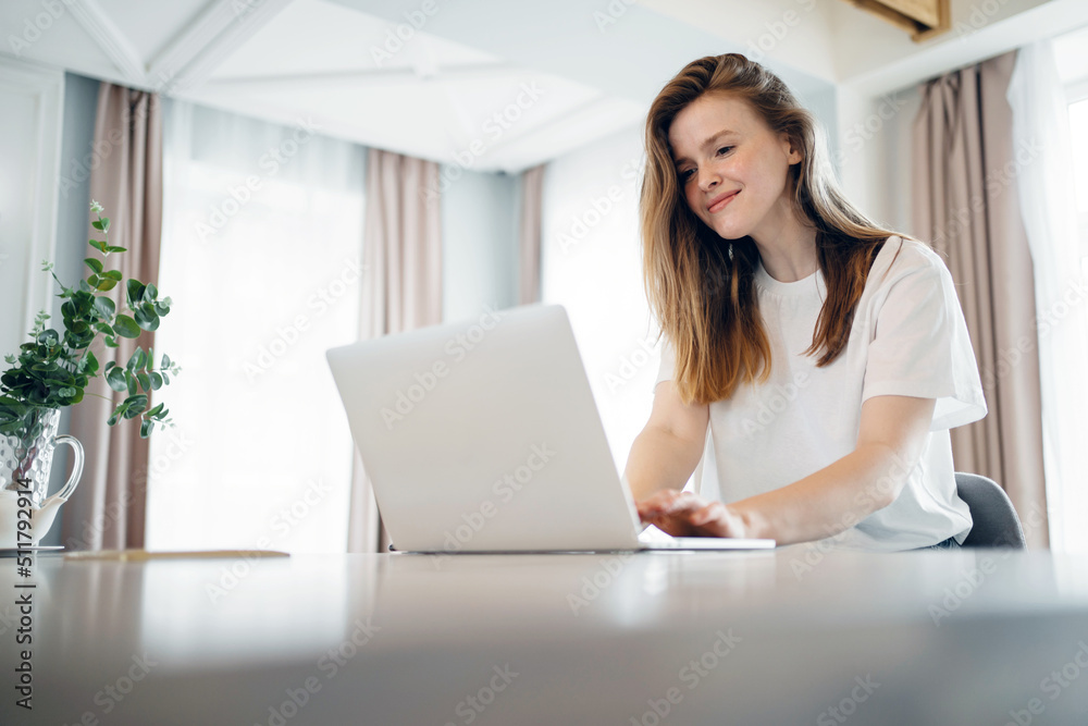 A woman uses a laptop computer at home online training, education remotely on the school's website A woman uses a laptop computer at home online training, education remotely on the school's website