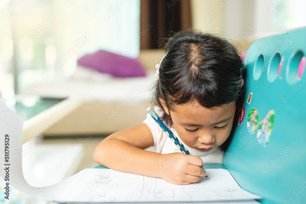Small Child Drawing On Blue Table At Home. Small Child Drawing On Blue Table At Home.