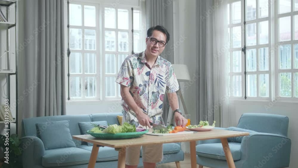Asian Man Smiling To Camera While Cook Healthy Food At Home
Asian Man Smiling To Camera While Cook Healthy Food At Home