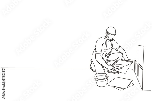 Single one line drawing repair worker laying ceramic wall tile. Professional tiler in uniform working. Repairman in overalls tiling at home. Continuous line draw design graphic vector illustration photo