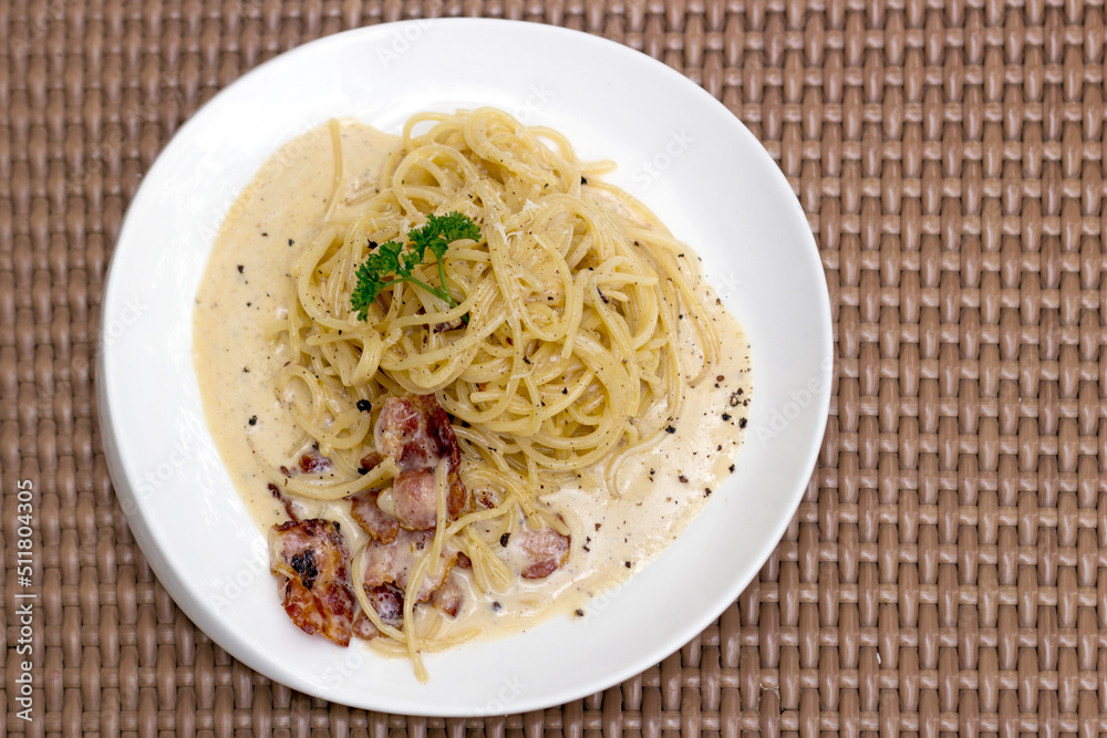 Carbonara spaghetti white cream with bacon and black pepper