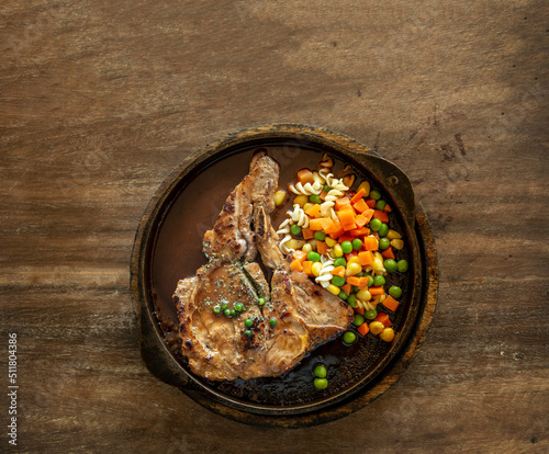 hot t-bone pork stake with vegetable with gravy sauce