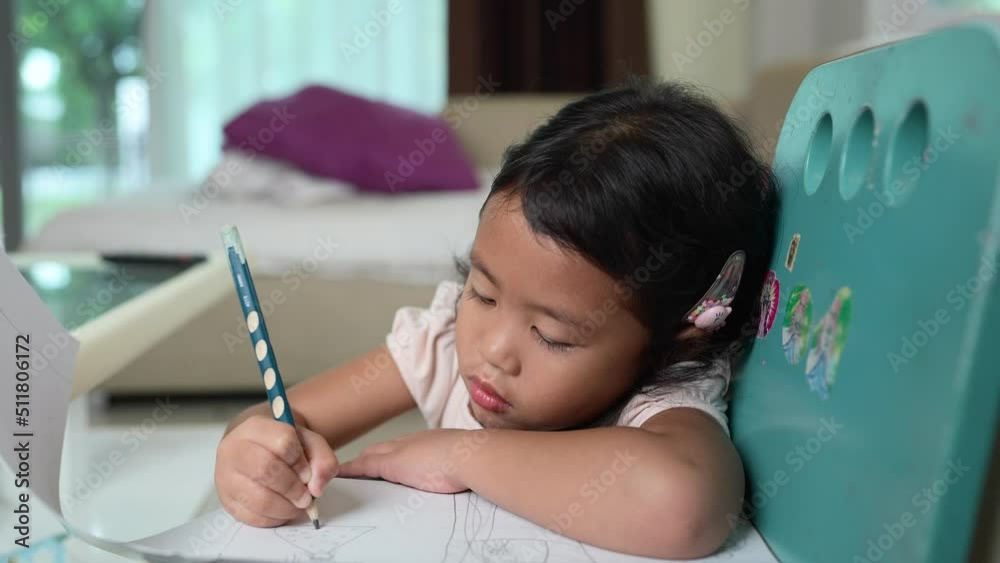 Small Child Drawing Picture On Blue Chair Indoor At Home. Small Child Drawing Picture On Blue Chair Indoor At Home.