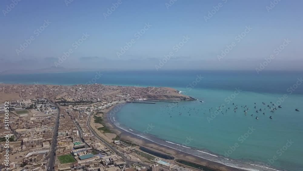 beautiful aerial drone view of a turquoise sea on the shore with many boats fishing in Huacho, lima, peru in 4k beautiful aerial drone view of a turquoise sea on the shore with many boats fishing in Huacho, lima, peru in 4k