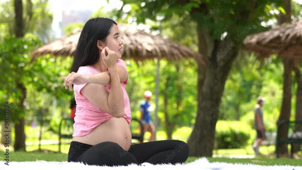 Pregnant woman touching belly in the City Park, Pregnant Relaxing and exercise, Beautiful tender mood photo of pregnancy Pregnant woman touching belly in the City Park, Pregnant Relaxing and exercise, Beautiful tender mood photo of pregnancy
