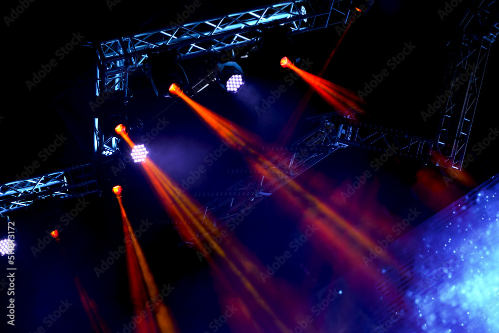 Fototapeta premium Crowd at concert - Cheering crowd in bright colorful stage lights