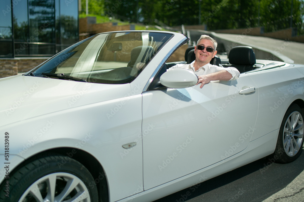 Successful happy man in the convertible. Luxury life Successful happy man in the convertible. Luxury life