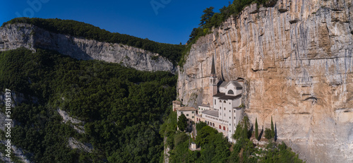 An old church, built around 1625, on the slope of the cliff. Madonna della Corona Sanctuary aerial panorama, in Italy. Church in the rock, Santuario della Madonna della Corona.