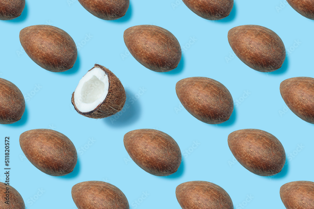 A pattern of a coconut kernel and one half of a coconut on a blue background. Coconut milk. Broken coconut. A wallpaper for a desktop of a computer or home screen on a mobile phone. A pattern of a coconut kernel and one half of a coconut on a blue background. Coconut milk. Broken coconut. A wallpaper for a desktop of a computer or home screen on a mobile phone.