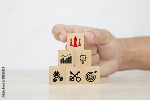 Hand choose cube wooden blocks stack with king chess with graph icon on business strategic plan concept of financial research for management to success and growth and strategy planning.