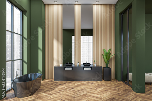 Green bathroom interior with double sink and tub near panoramic window