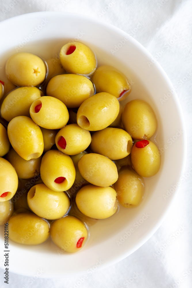 Marinated Green Olives with Pimento Peppers in a Bowl, top view. Flat lay, overhead, from above. Marinated Green Olives with Pimento Peppers in a Bowl, top view. Flat lay, overhead, from above.