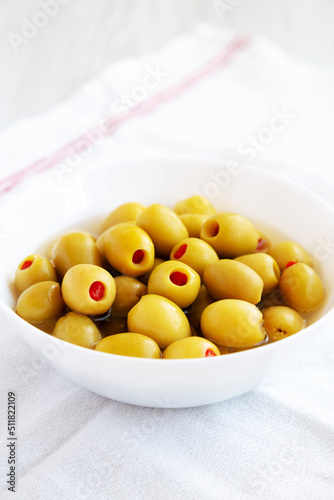 Marinated Green Olives with Pimento Peppers in a Bowl, side view.