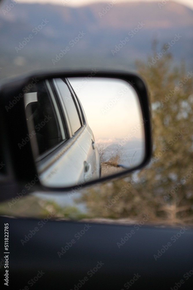car travel concept reflection in rear mirror