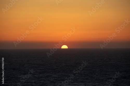 sun disk at sea horizon colorful sunset