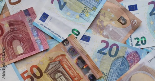 Euro banknotes in various denominations. Pile of banknotes on the table. Background of mixed euro banknotes photo