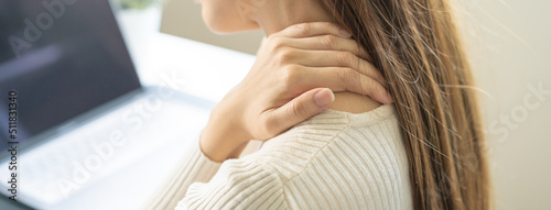 Body muscles stiff problem, ache asian young woman, girl pain neck while sitting work on chair at home, holding massaging rubbing, hurt or sore, Healthcare people, office syndrome . photo