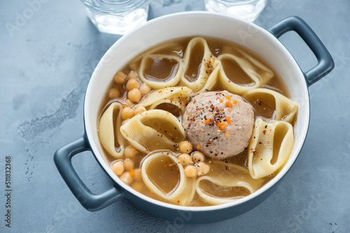 Serving pan with catalan escudella on a grey concrete background, horizontal shot, elevated view