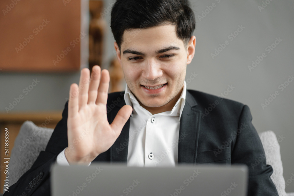 Freelancer man in a business suit chatting online video call with colleagues Freelancer man in a business suit chatting online video call with colleagues