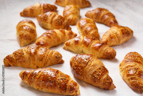 Lots of crispy ruddy croissants on a white background