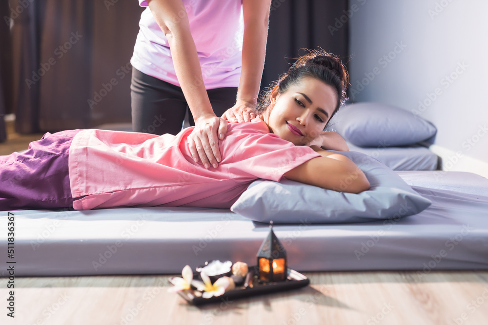 Thai back massage on bed to beautiful Asian woman in spa Thai back massage on bed to beautiful Asian woman in spa