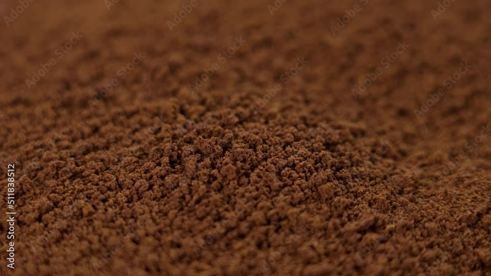 Instant coffee particles. Natural brown roast stimulant. Rotation. Falling in slow motion Instant coffee particles. Natural brown roast stimulant. Rotation. Falling in slow motion