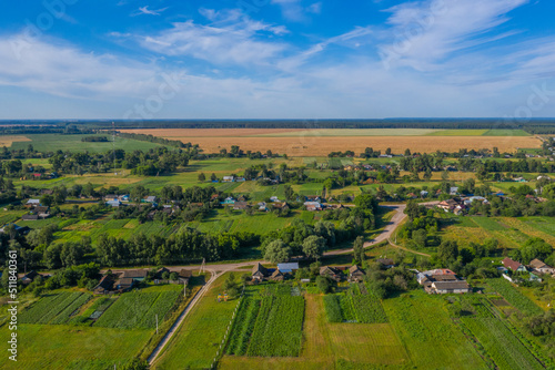 Aerial view over beautiful suburb in  wide valley, in the summer.  Top view to the small village with a beautiful green landscape. © Valua Vitaly