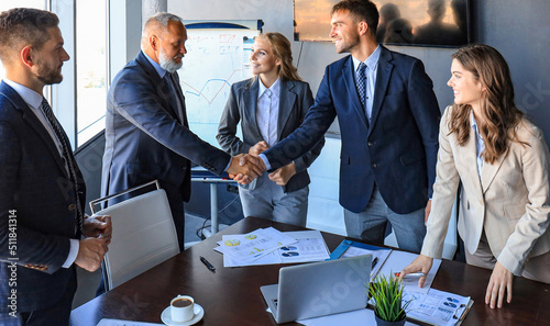 Business people shaking hands, finishing up a meeting.