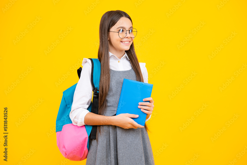 Back to school. Schoolgirl student hold book on yellow isolated studio background. School and education concept. Teenager girl in school uniform. Back to school. Schoolgirl student hold book on yellow isolated studio background. School and education concept. Teenager girl in school uniform.