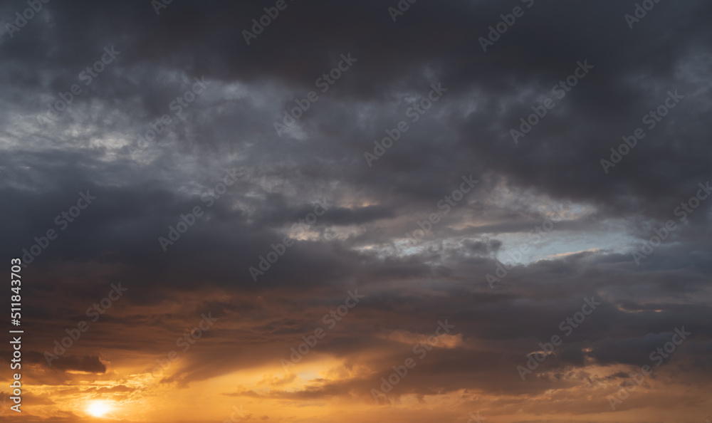 Dramatic sunset with dark stormy clouds