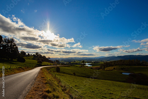 Road to the valley with lake and a cloudy sky in Tasmania / Australia.