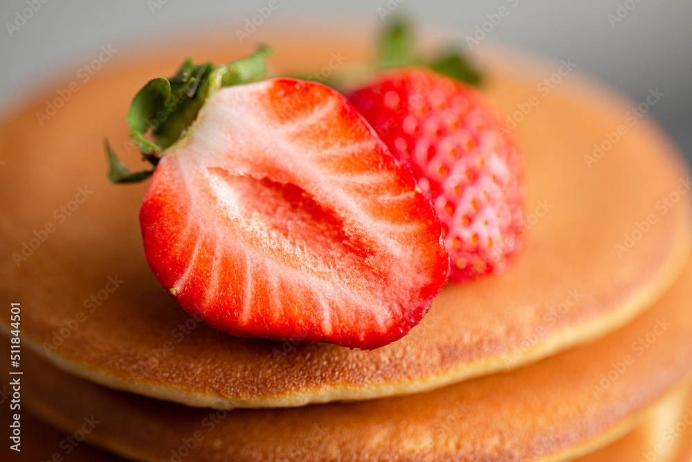 Pancakes for breakfast. Cover with pancakes. A stack of pancakes on a wooden board with honey. Honey pours on pancakes. Dessert. Favorite breakfast. Beautiful food cover.American breakfast. Pancakes for breakfast. Cover with pancakes. A stack of pancakes on a wooden board with honey. Honey pours on pancakes. Dessert. Favorite breakfast. Beautiful food cover.American breakfast.