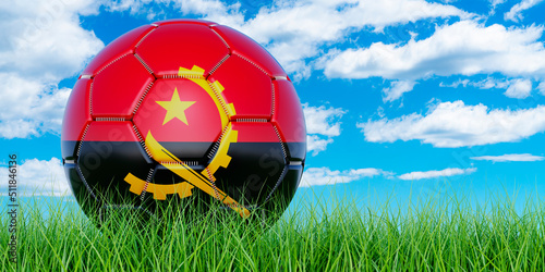 Soccer ball with Angolan flag on the green grass against blue sky, 3D rendering