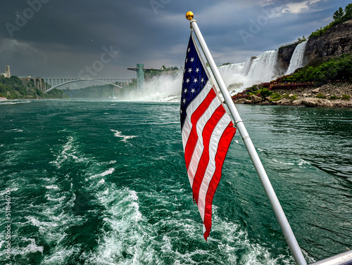 American USA Flag in front of the Niagara Falls in New York and Canada